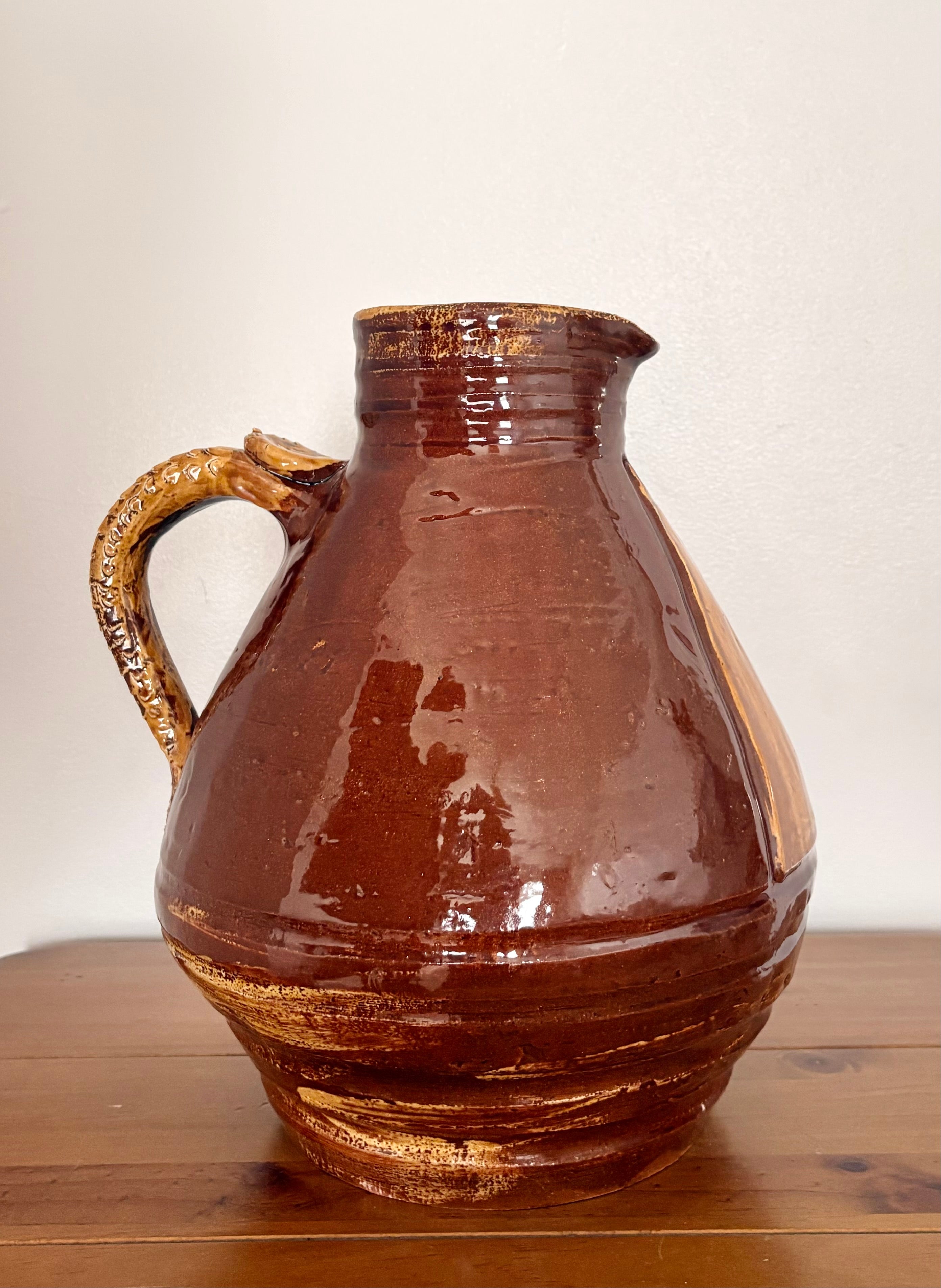 Large earthenware jug with a serpent handle