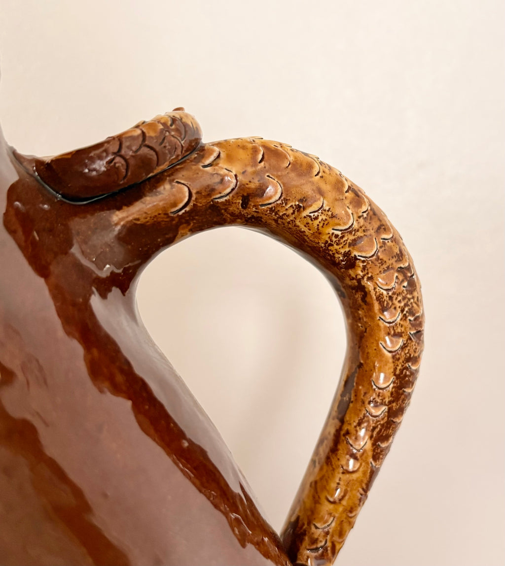 Large earthenware jug with a serpent handle